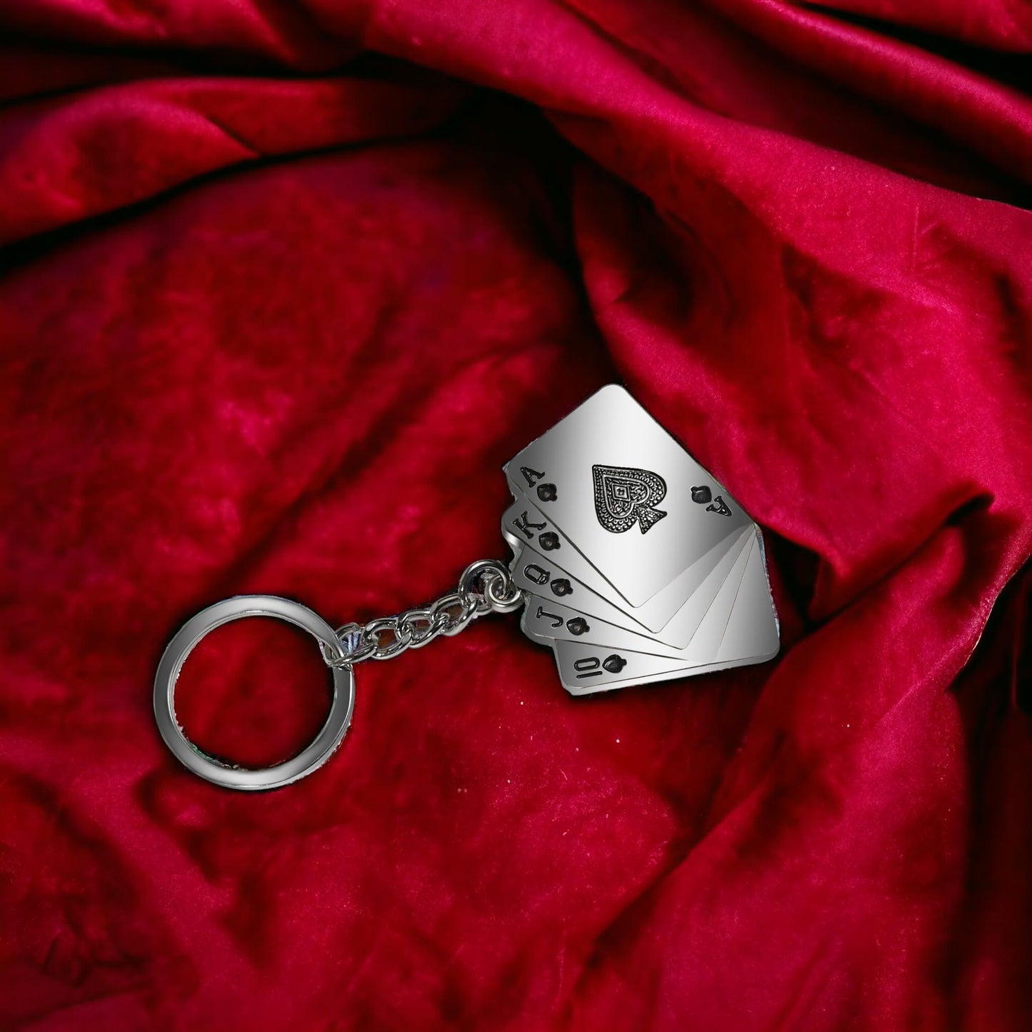 Look of poker keychain on red sheet